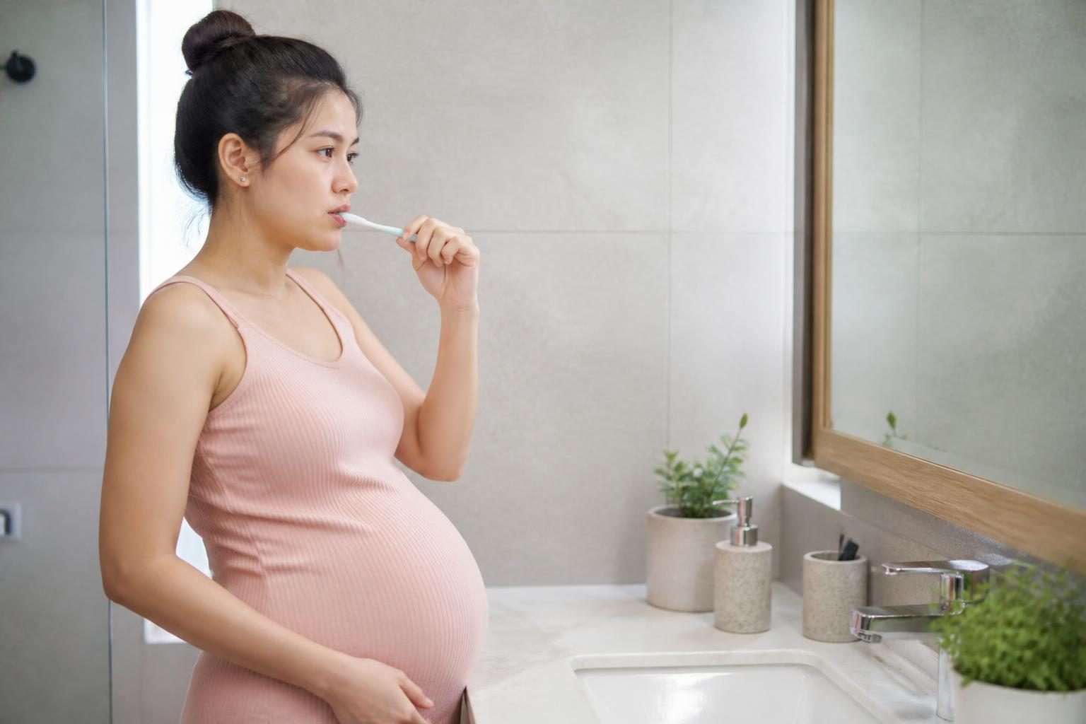 Mẹ bầu chải răng nhẹ nhàng bằng bàn chải mềm, chăm sóc răng miệng khi niềng răng khi mang bầu - ảnh minh hoạ